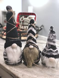 three knitted gnomes sitting next to each other