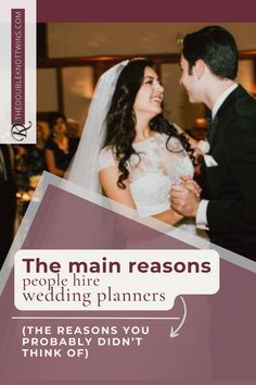 a man and woman standing next to each other in front of a wedding reception table