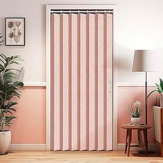 an open door with pink and white vertical blinds in a room next to a potted plant