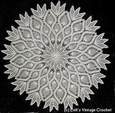 a white doily on a black background