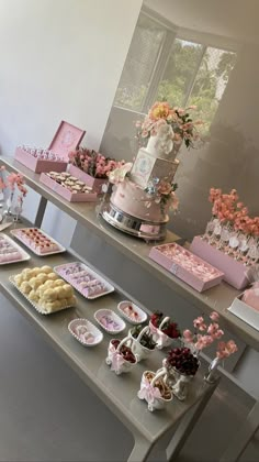 a table filled with cakes and desserts on top of it