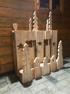 a wooden castle made out of pieces of wood