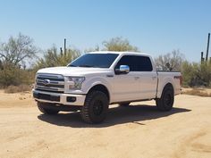 a white truck is parked in the desert