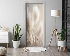 an open door in a room with potted plants and a rug on the floor