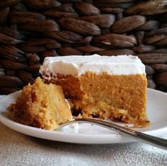 a piece of cake on a plate with a fork next to it and a woven basket in the background