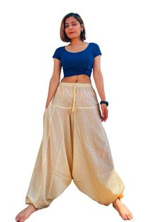 You are viewing boho/ hippy/festival, a pair of Aladdin Harem trousers.  Features:     ✔Elastic fitted waist and ankle which make it suitable for most of the adult sizes     ✔Elasticated Waist: 26-38 Inches(will fit any size in between)    ✔ Length: 39-40 Inches((will fit any length in between))     ✔Material: Upto 60% organic hemp + 40 % cotton fiber applied loom fabric     ✔Quality: Relatively strong, yet soft fabric      ✔Drawstring waist     ✔Two side pockets ☑Hemp Fabric/Fiber is sustainabl White Harem Bottoms For Festival, White Bohemian Full Length Bottoms, White Full-length Bohemian Bottoms, White Bohemian Baggy Harem Pants, White Baggy Bohemian Harem Pants, White Baggy Bohemian Bottoms, White Hippie Pants For Summer, Traditional Baggy Bottoms For Spring, White Bohemian Harem Pants For Summer