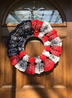 a patriotic wreath is hanging on the front door