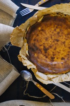 a pie sitting on top of a table next to utensils and napkins