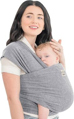 a woman holding a baby in a grey wrap