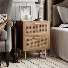 a living room scene with focus on the bedside table and chair, which is next to a bed