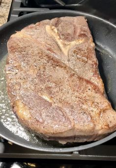 a steak is cooking in a skillet on the stove