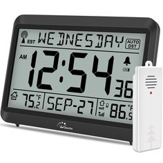 an alarm clock and thermometer are on display