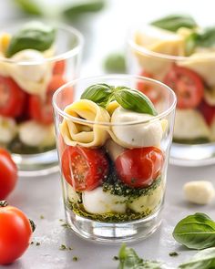 three small glasses filled with pasta and vegetables