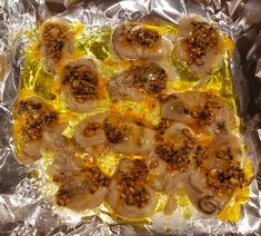 cooked scallops on aluminum foil with mustard and seasoning