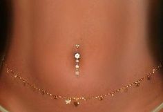 a woman's stomach with gold jewelry on it