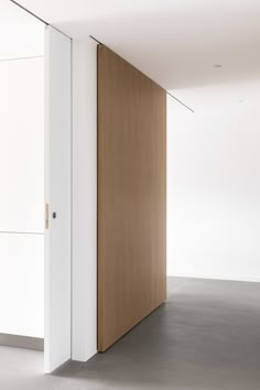 an empty room with white walls and wooden doors