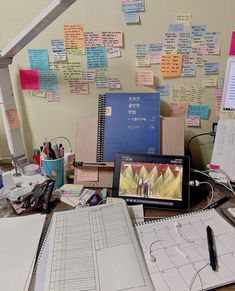 a cluttered desk with many papers on it