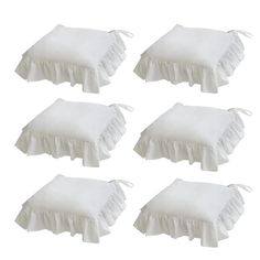 six white pillows with ruffles on them