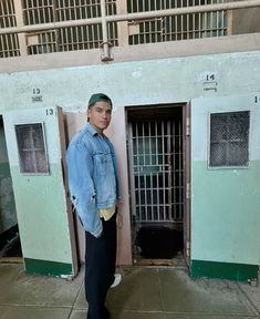 a man standing in front of jail cell doors