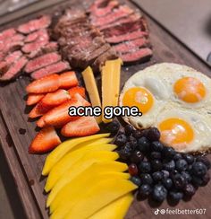 some food is laying out on a wooden tray with words that read, acne gone