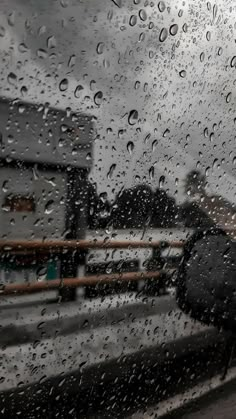 a person with an umbrella standing in the rain