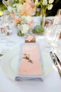 the table is set with wine glasses and place cards for guests to use on their wedding day