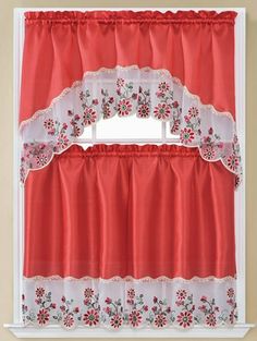 a window with red curtains and flowers on it