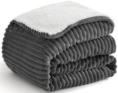 stack of towels folded on top of each other in grey and white colors, isolated against a white background