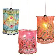 three different colored lamps hanging from the ceiling with lights on each side and one light in the middle