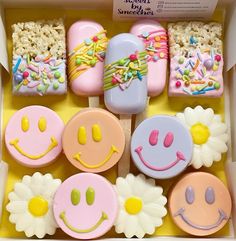 a box filled with lots of decorated cookies and marshmallows on top of each other