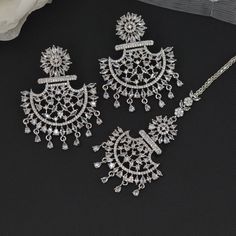 This American Diamond CZ Chandbali  Earrings and Maang Tikka Set are the ultimate in versatile  Indian jewelry. Wear them together or Tikka and Earrings Their own. you can create three different looks with one set.  Earrings drop length is 5.5cm and width 4cm Tikka: L12x3cm This gorgeous pair is made on brass as base metal and handcrafted to perfection with studded white , CZ stones, and Mint Green semi precious stone Droplets. you don't have to opt for the minimalistic all the time. Sometimes it's better to go OTT. Elegant Wedding Tikka With Intricate Design, Elegant Chandbali Sets With Matching Earrings, Elegant Chandbali Chandelier Earrings For Wedding, Elegant Dangle Chandbalis For Wedding, Festive Cubic Zirconia Jewelry Sets For Wedding, Traditional Bridal Sets With Matching Earrings For Wedding, Wedding Chandelier Earrings With Cubic Zirconia, Festive Wedding Jewelry Sets With Cubic Zirconia, Festive Wedding Chandelier Earrings Cubic Zirconia