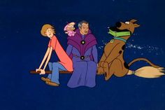 scooby and friends sitting on the ground in front of an image of a dog