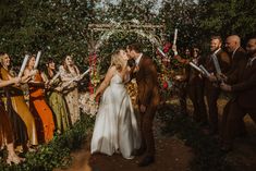 a bride and groom kissing in front of an outdoor ceremony