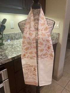 a kitchen towel hanging on a rack in front of a stove top oven and counter