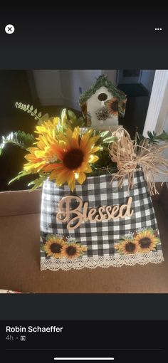 a vase filled with sunflowers on top of a table