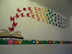 an open book is flying through the air with colorful butterflies coming out of its pages