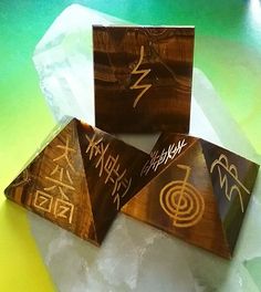 "A large stunning TIGER EYE 4 sided pointed healing energy tower obelisk or wand. Measures approximately 4\" high and 1\" wide measured diagonally at the base. One of the more powerful bodywork tools you'll ever find! Pointed at one end. I have engraved usui reiki symbols on all 5 sides. Below are the 5 reiki symbols and their meaning. 1.) CHO KU REI ~ The Power Symbol 2.) SEI HE KI ~ The Emotional Symbol 3.) HON SHA ZE SHONEN ~ The Distance Symbol 4.) DAI KU MYO ~ The Master Symbol 5.) RAKU - C Eye Pyramid, Reiki Practice, Cho Ku Rei, Usui Reiki, Pyramid Eye, Reiki Symbols, Tiger Eye Crystal, Symbols And Meanings, Power Symbol