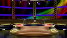 a woman standing on top of a stage in front of a set of tv screens