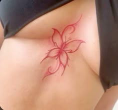 a woman's stomach with a flower tattoo on the bottom part of her belly