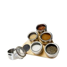 an assortment of spices on a wooden tray