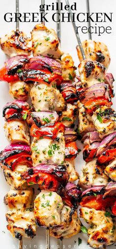 chicken kabobs on skewers with red onions and herbs