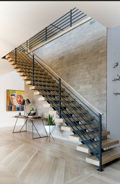 a staircase in a modern home with wood floors