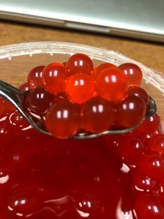 a spoon full of jelly sitting on top of a table