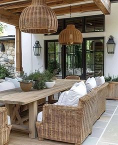 an outdoor dining area with wicker furniture