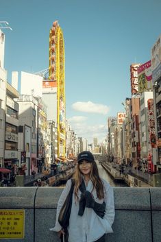 a woman standing in front of a city street