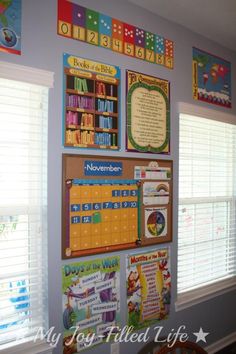 a child's room decorated with calendars and books