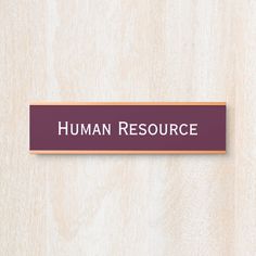 a wooden sign that says human resources on the side of a wall with wood paneling