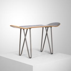 two metal and wood tables sitting on top of a white surface