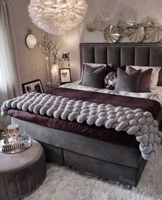 a large bed sitting in a bedroom on top of a white fluffy carpeted floor