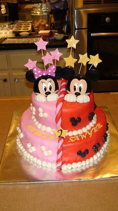 two mickey and minnie mouse cakes on a table